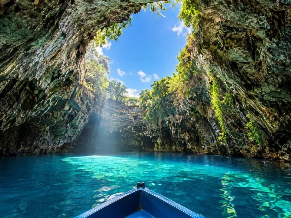 Sunlight through the collapsed roof onto the turquoise water of Melissani Lake