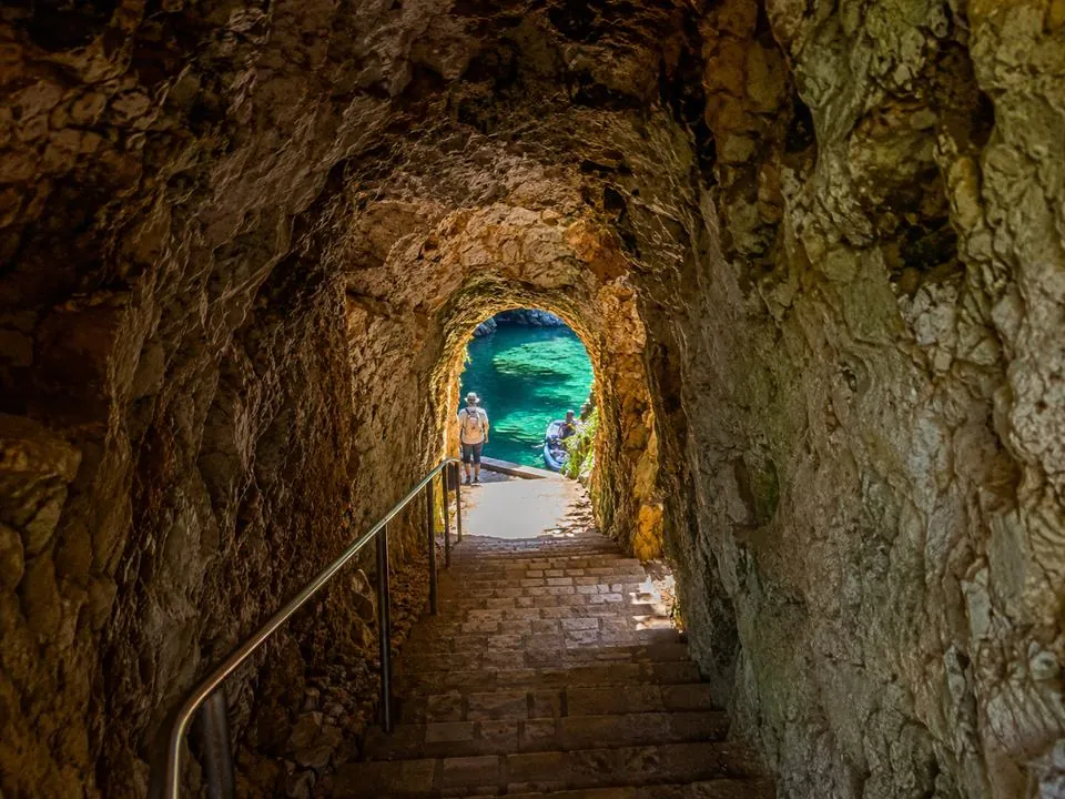 The sloping stone-stepped tunnel down to the Melissani pier